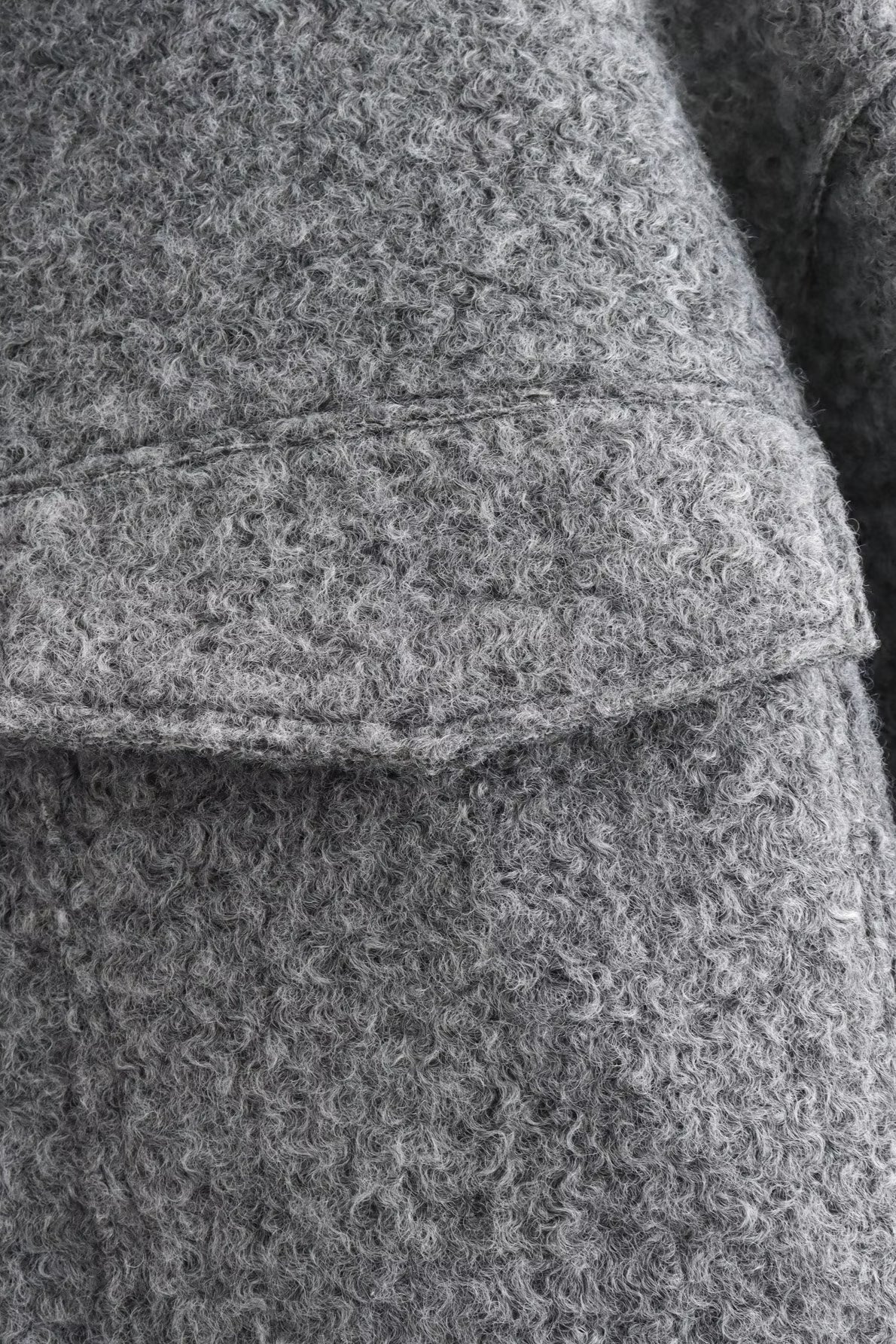 Vue arrière d’une veste femme courte en bouclé au style contemporain