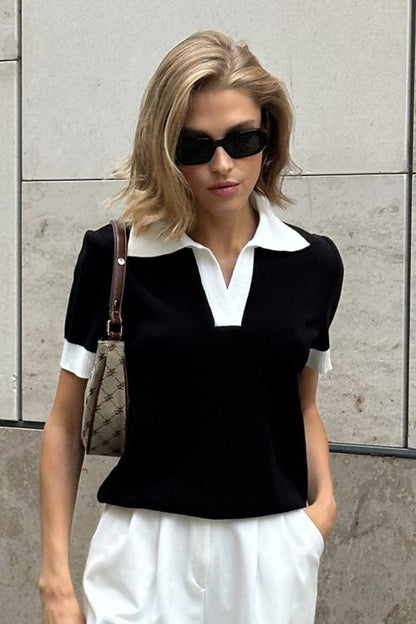 Gros plan sur la maille du pull polo femme noir